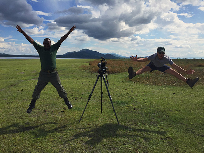 Dan Duran jumping for joy at Lake Burunge wit an anti-poaching scout