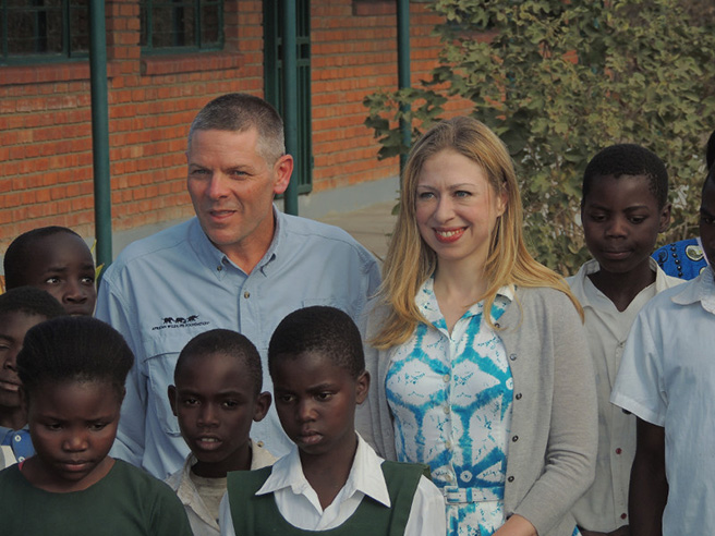 Chelsea Clinton, vice chair of Clinton Foundation, with African Wildlife Foundation CEO Patrick Bergin and Lupani Primary School children in August 2013