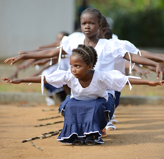 School girls perform a dance at the grand opening of the Ilima Conservation School.