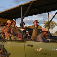 Photo of AWF staff and business leaders in safari vehicle