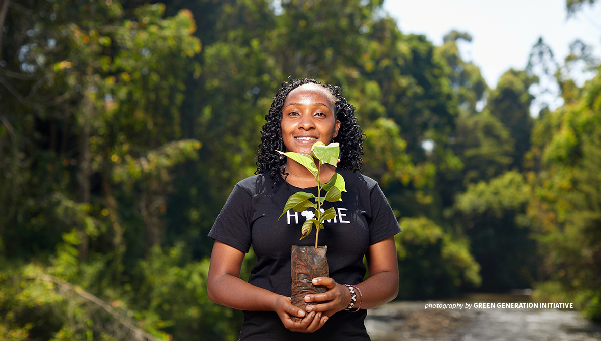 Photo of climate activist Elizabeth Wathuti holding a seedling