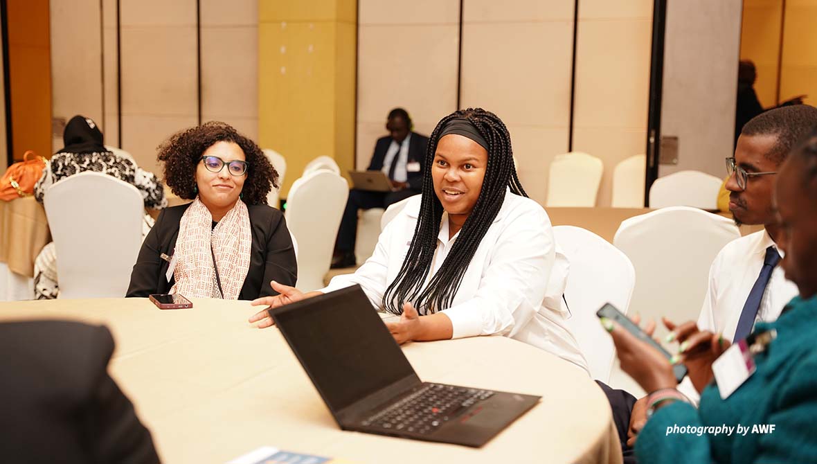 Simangele Msweli at a table at AMCEN