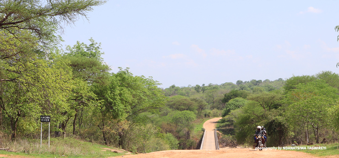 Wide shot of a road with a motorcycle