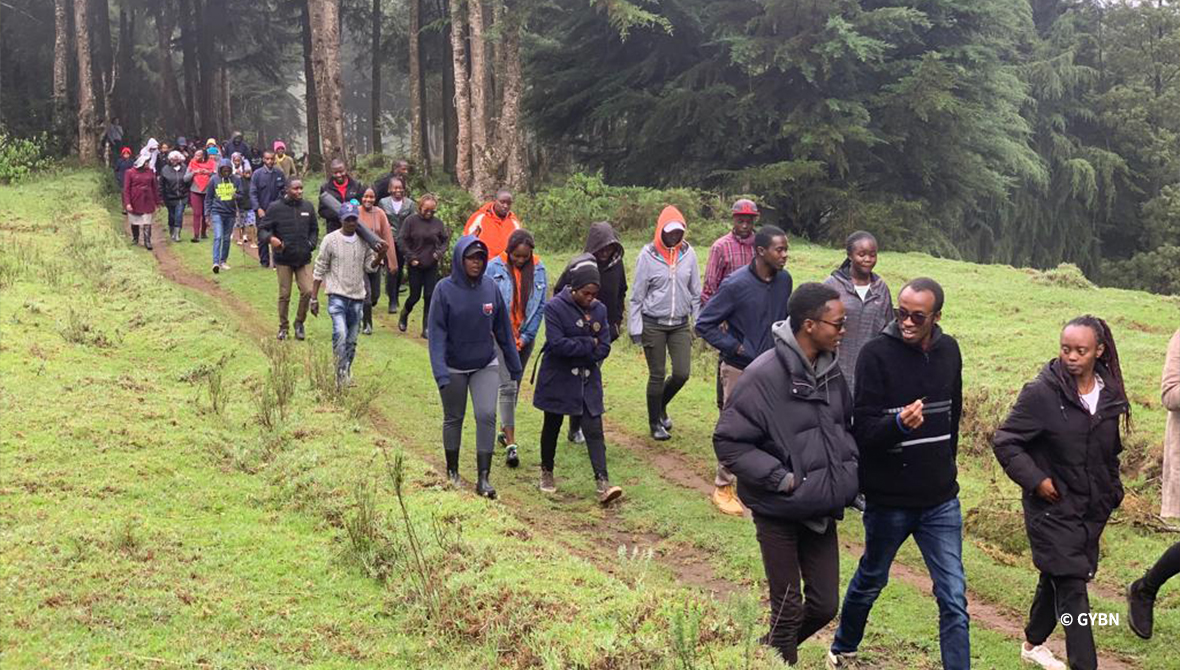 A group walking through a forest path.