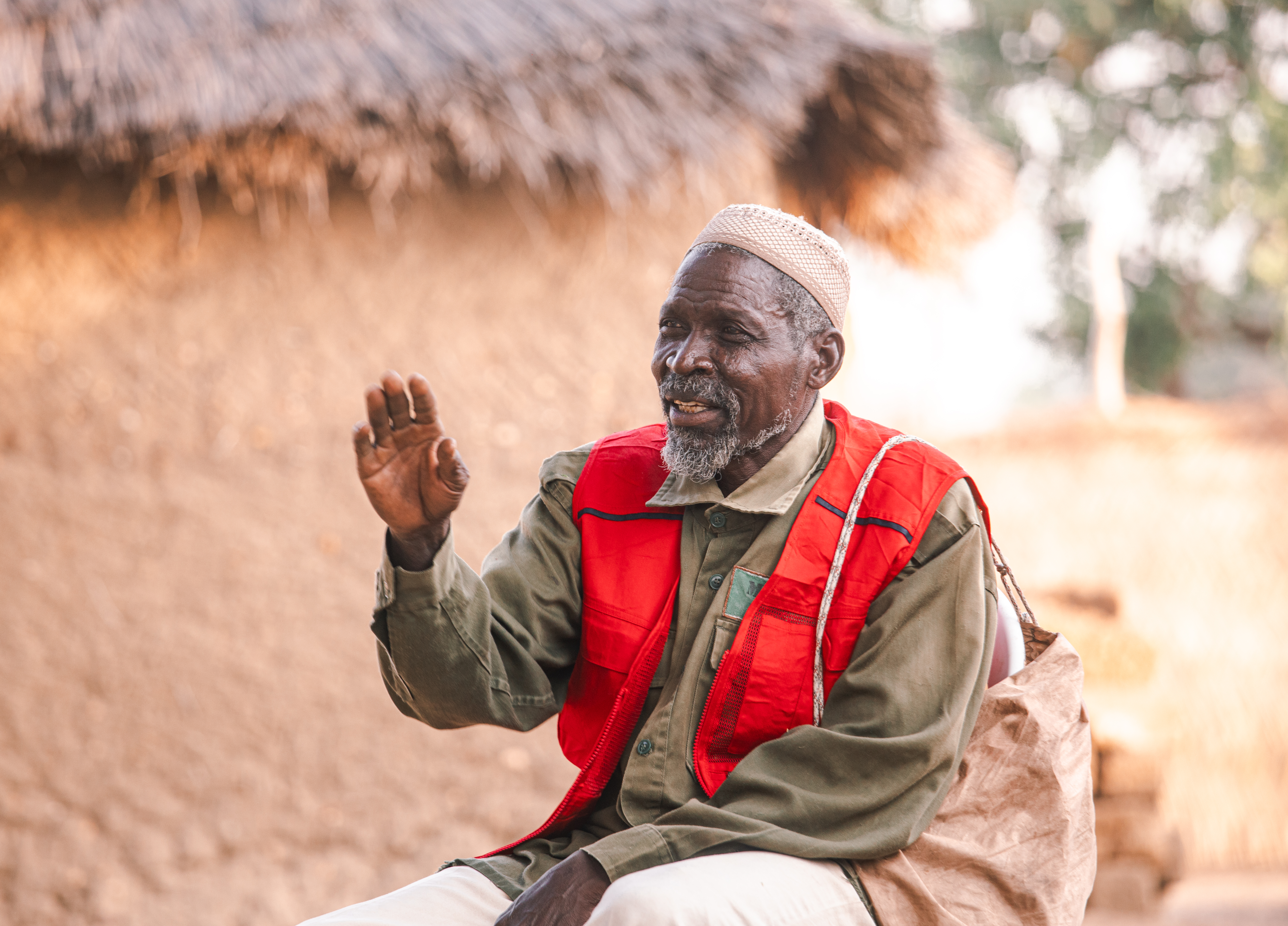 Papa Gambo sitting outside his house