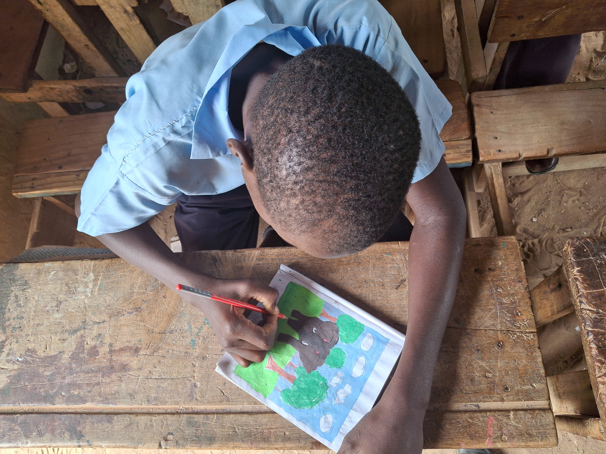Bakari drawing one of his artpieces 