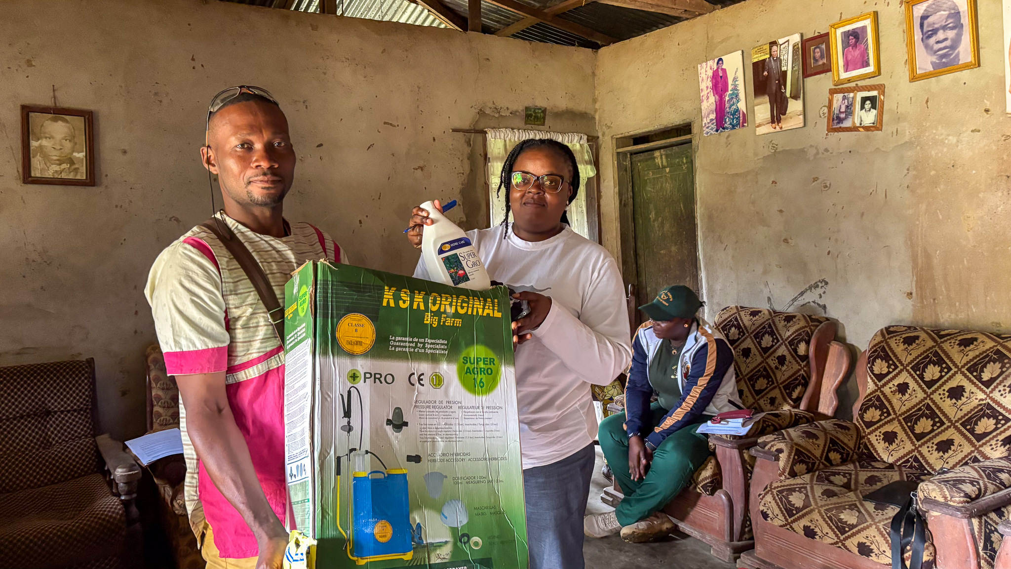 Yves receives advanced farming equipment from AWF Community Liason, Lydie Nguesse, in recognition of his impressive work under the project. 