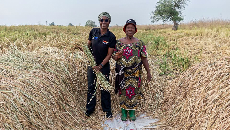 Aminatou Koffa and AWF Community Liaison Blandine Moueni together in the rice field. 