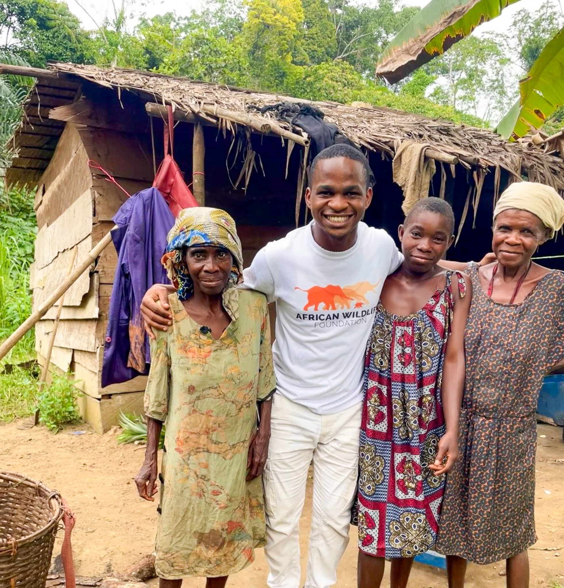 Yann Avoto (centre), AWF Biomonitoring assistant based in Campo stands alongside Indigenous Bagyeli women
