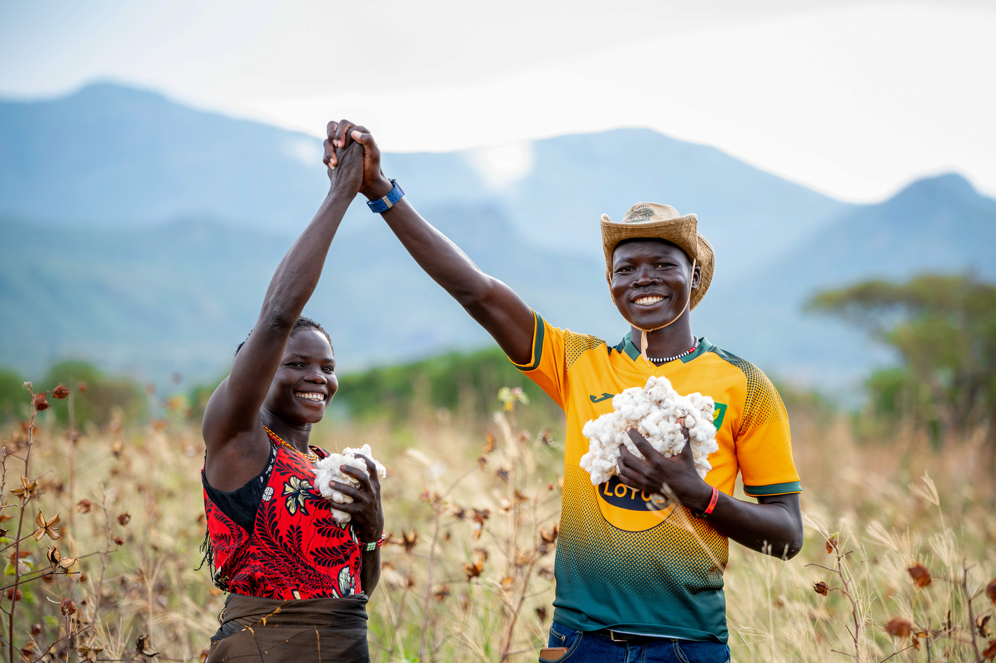Cotton farmers Victor Bari and Hellen Nakwang' celebrating the harvest on their farms.