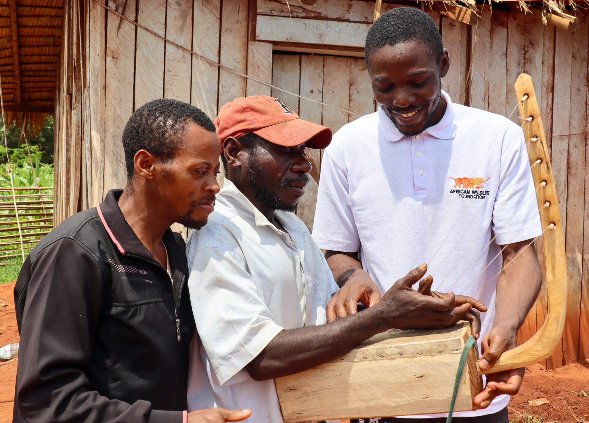 Ndamey Rene (far left) alongside a fellow community member and AWF Senior M&E Officer Antoine Melingui (far right) working hand in hand to conserve Dja Faunal Reserve.