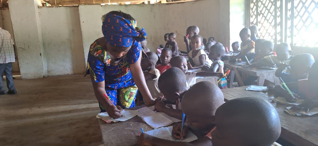 Rebecca Lokuli helping her students.