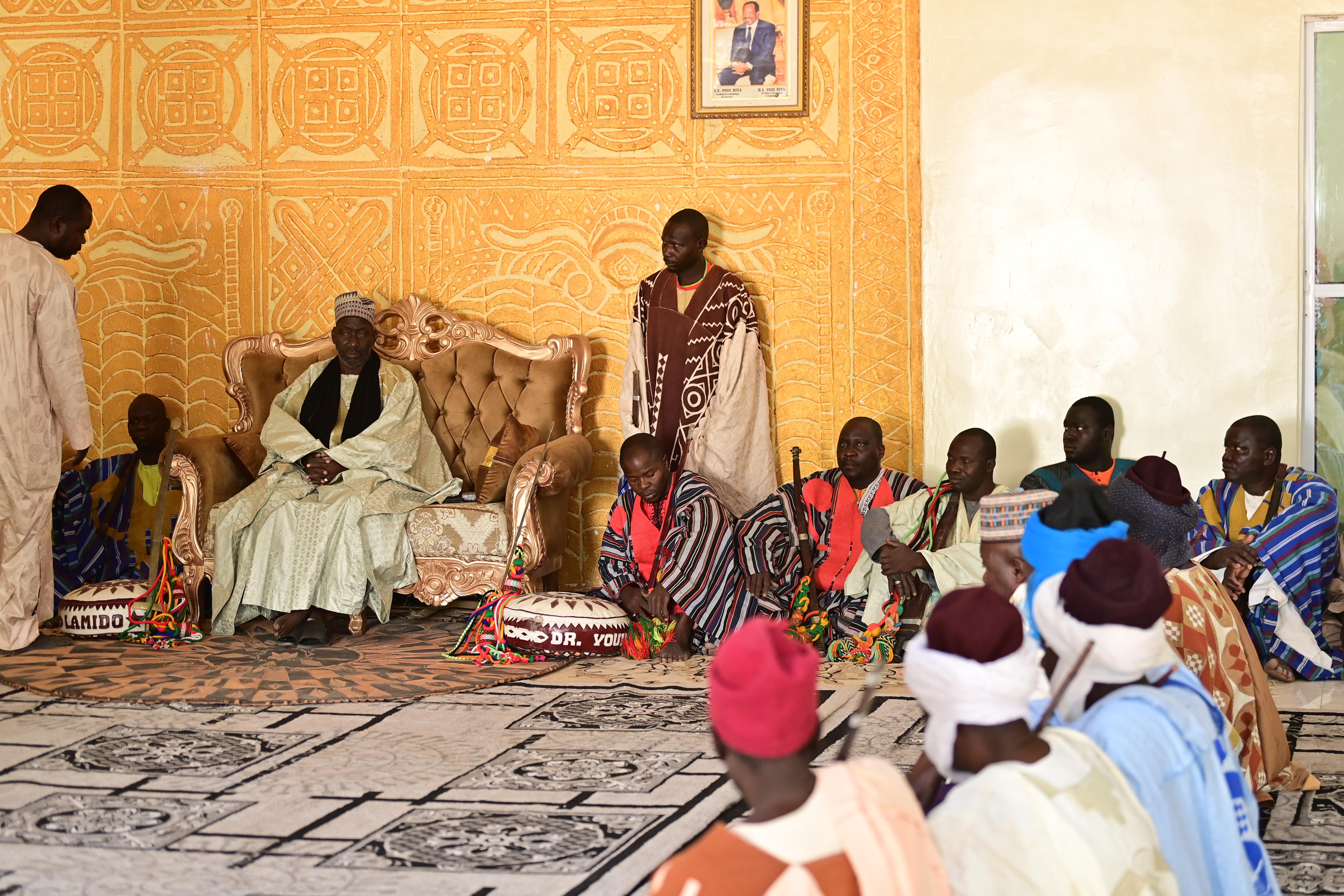 The Lamido of Tchamba, Dr. Youkouda Abdoulaye Koeranga sits in his palace alongside members of his council.