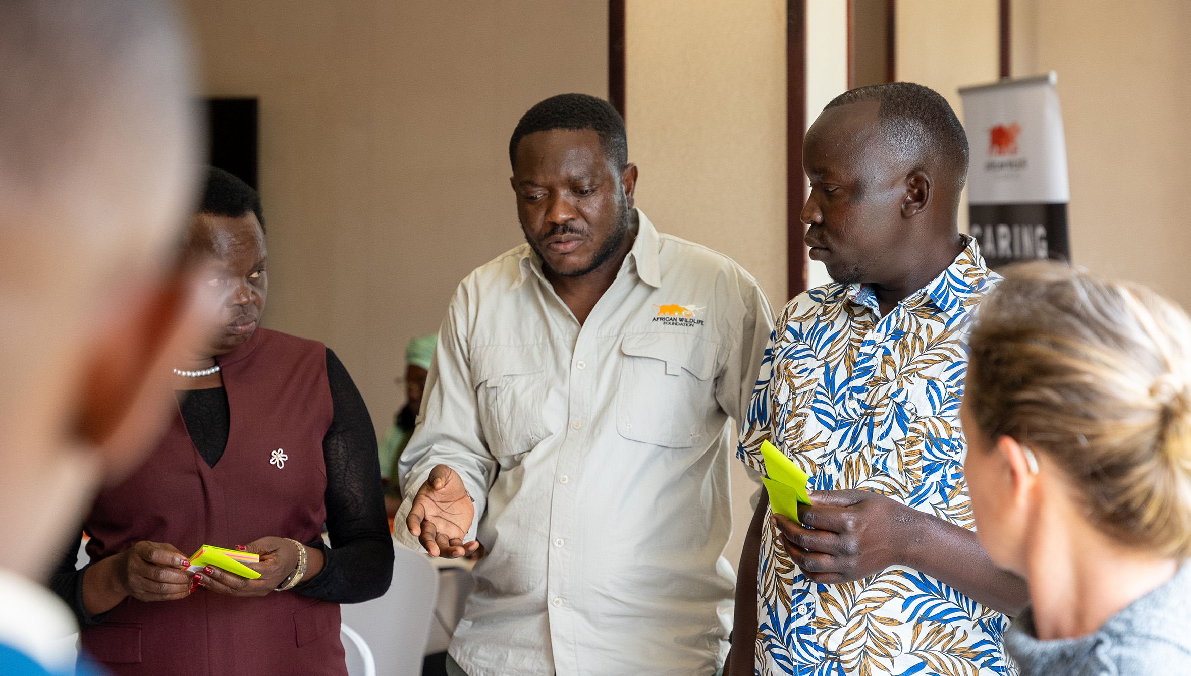Dodo Moke, AWF Environmental Social Safeguards and Conflict Sensitivity Manager, speaking with participants at the workshop in Kampala. 