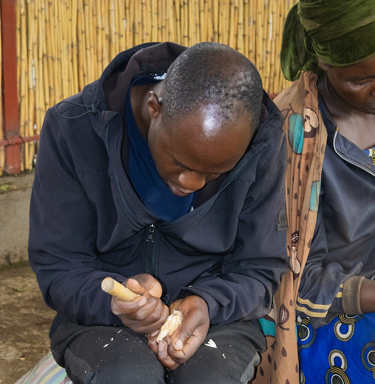 Murwanashyaka Martin carving a souvenir.
