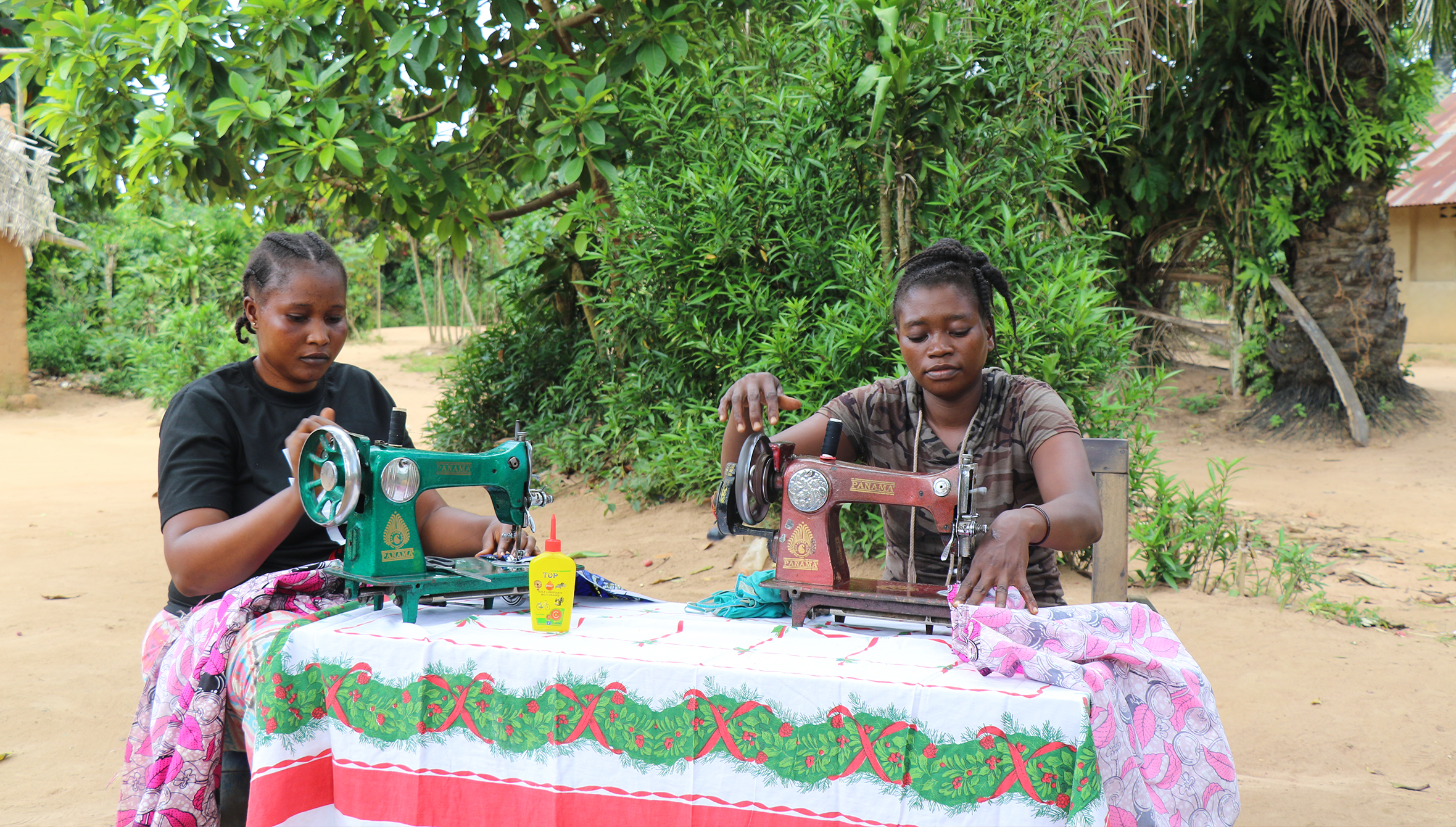 Two cousins practicing their sewing skills in their aunt’s compound, where she works as a trainer in Bongandanga.