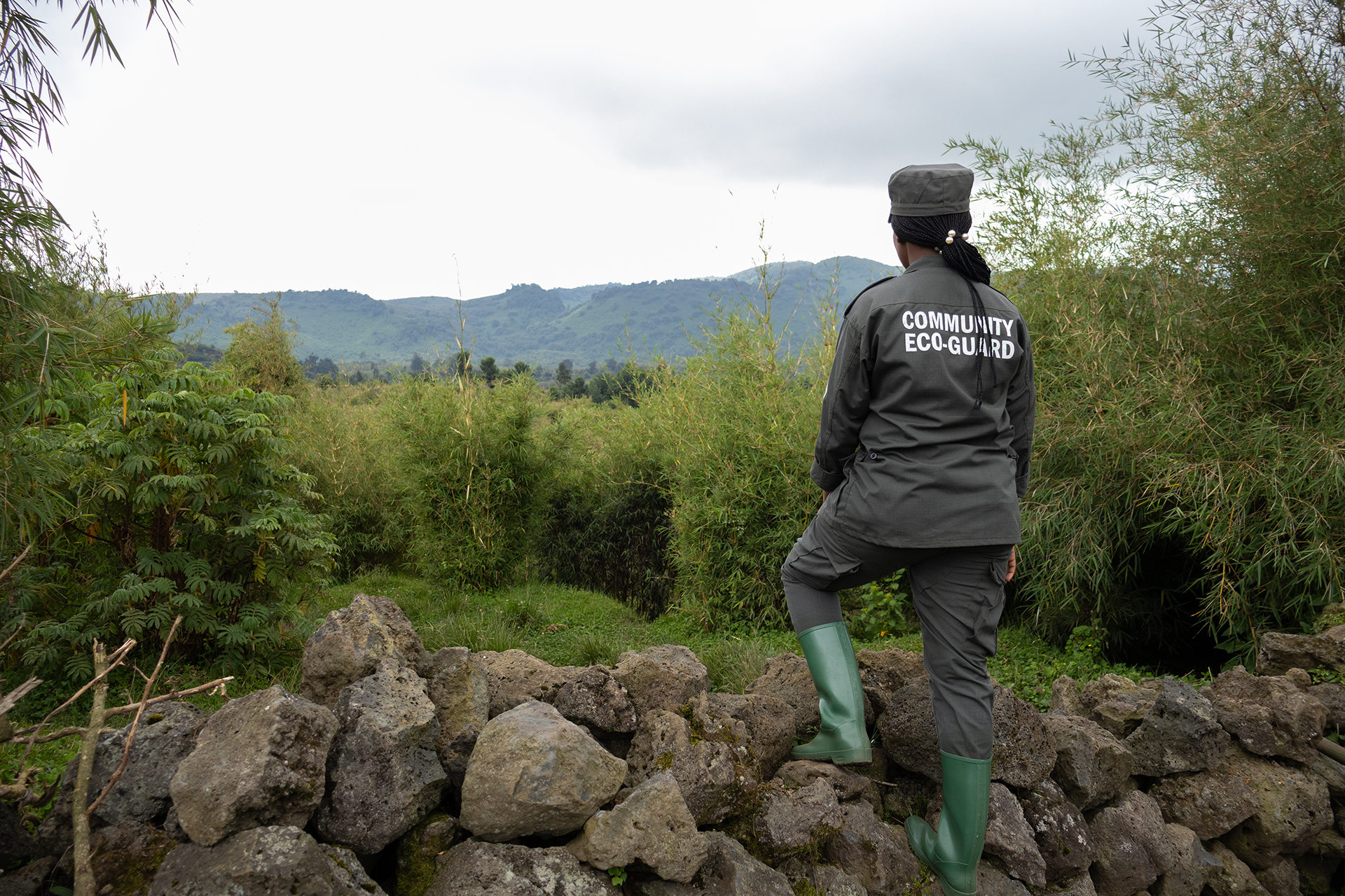 Umuhoza Aline on duty at the Volcanoes National Park boundary.