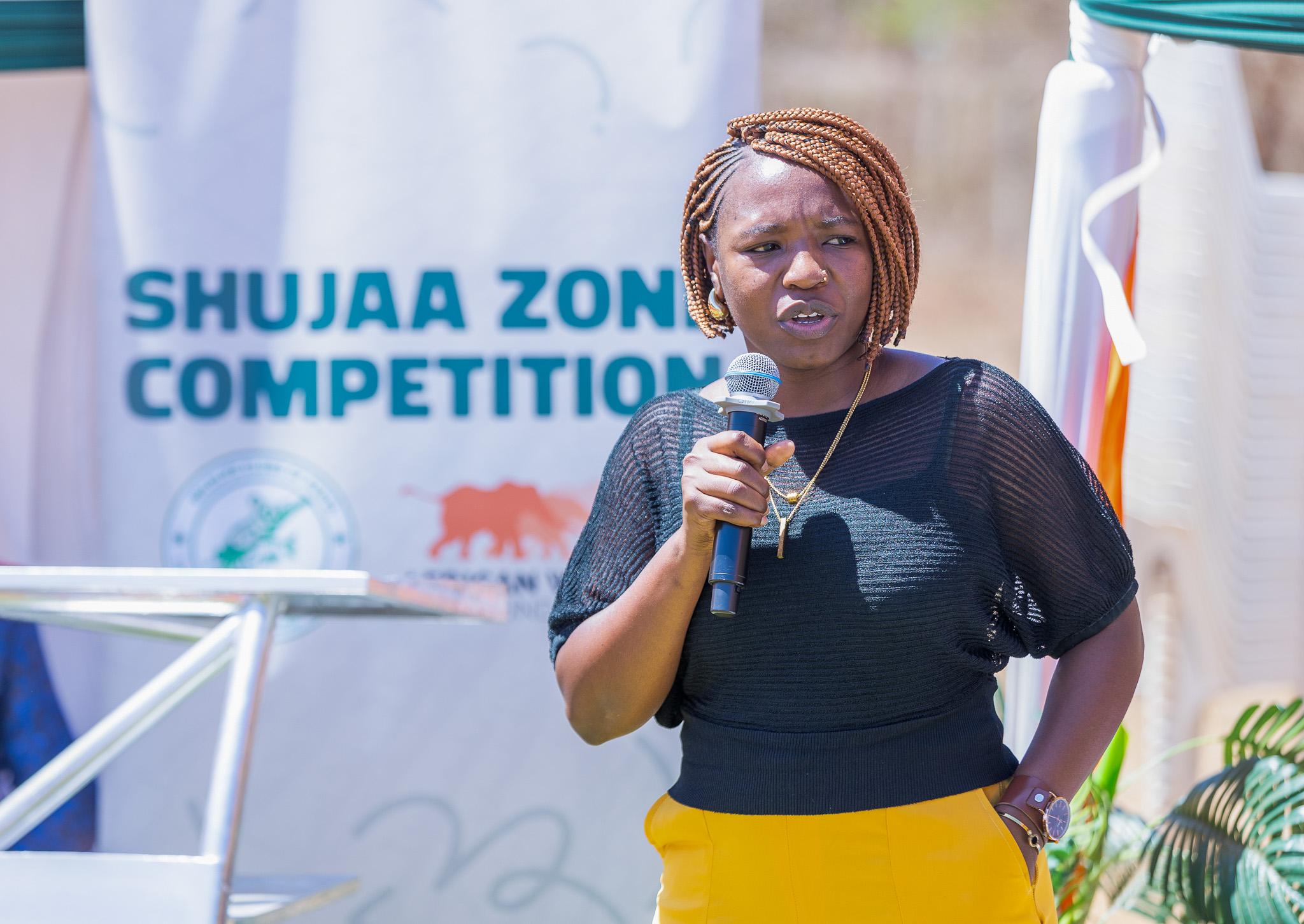 AWF Community Development Officer, Wanyika Wangio, addresses learners and guests during the Shujaa Zone Competition Award Ceremony.