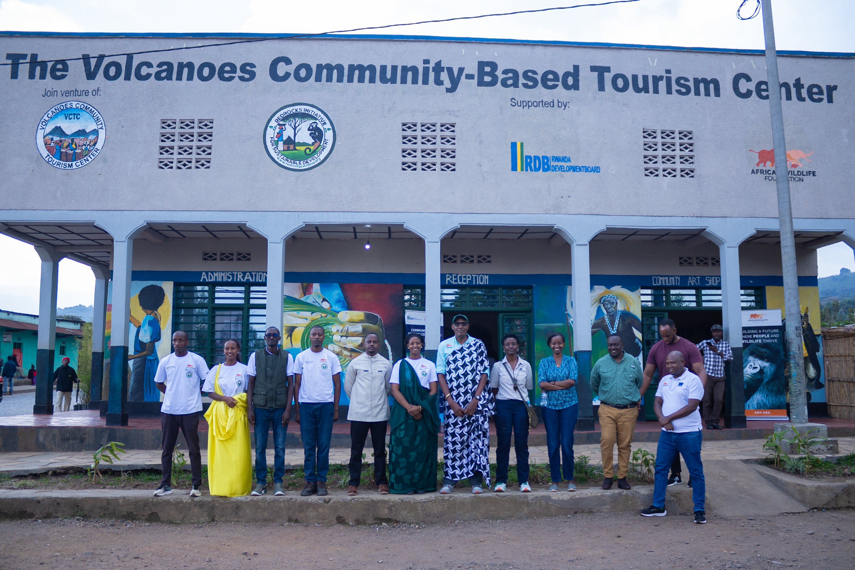 AWF CEO Kaddu Sebunya with staff members and partners at the Community-Based Tourism Center in Kinigi, Rwanda.