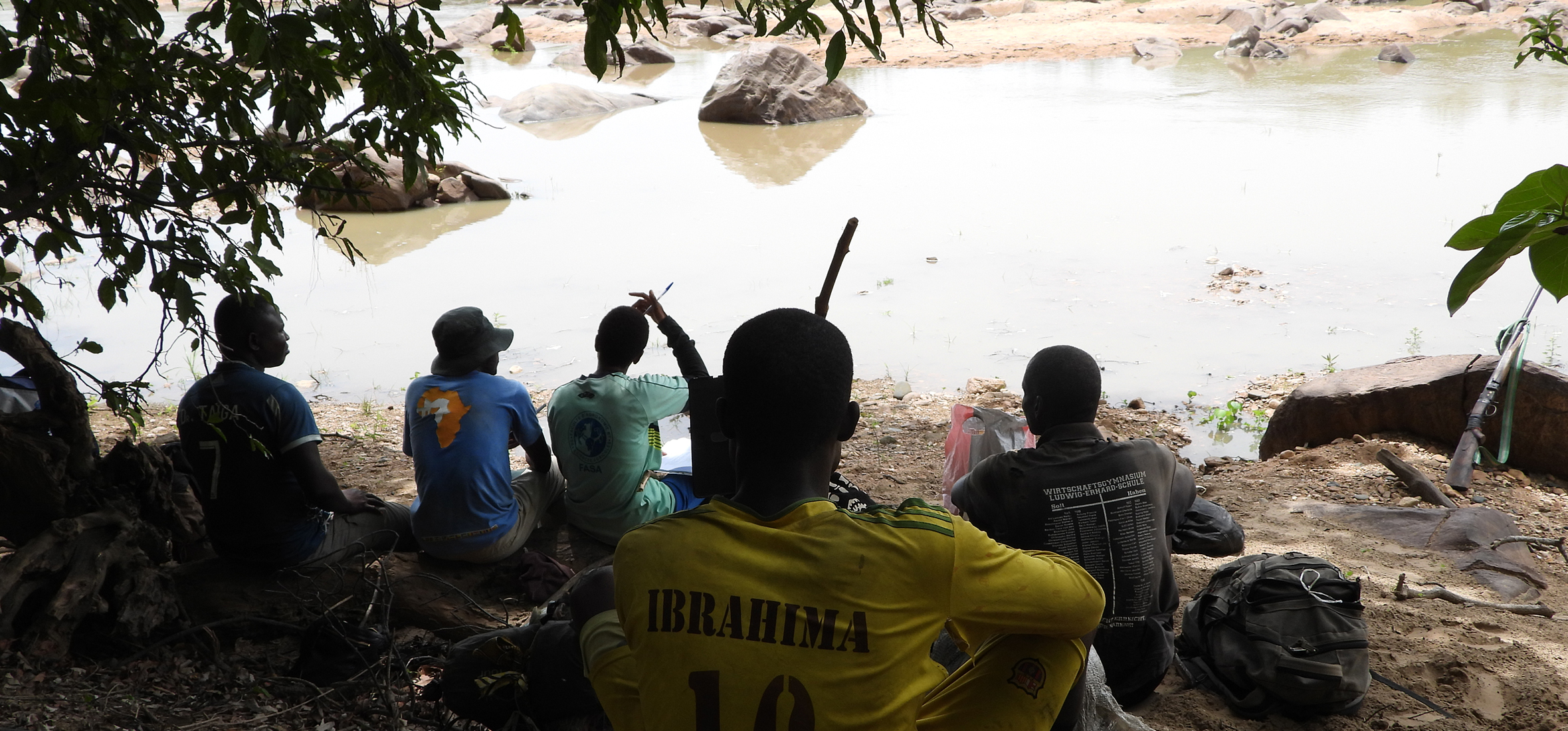 Community members in Faro gather along a riverbank to monitor and protect local hippopotamus populations—a powerful reminder that lasting wildlife conservation starts at the local level.