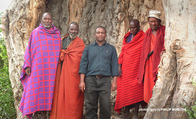 Photo of lion researcher Dr Bernard Kissui with Maasai pastoralists in Tanzania