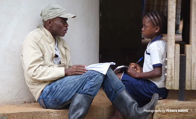 Photo of AWF Senior Field Officer in Maringa-Lopori-Wamba speaking to primary school student Photo of AWF Senior Field Officer in Maringa-Lopori-Wamba speaking to primary school student