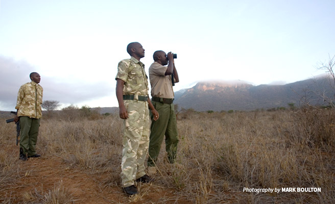 Photo of three wildlife rangers conducting a morning patrol in Tsavo, Kenya
