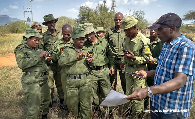 Photo of LUMO conservancy community wildlife scouts trained on ecological monitoring by AWF staff member