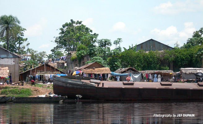 Photo of AWF-funded barge transporting agriculture produce stopped at market town on river bank