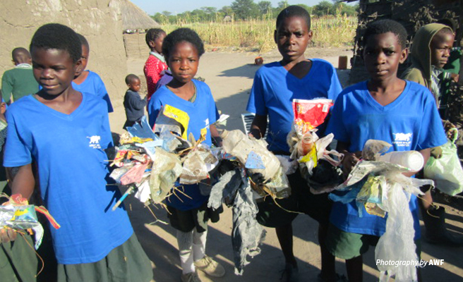 Photo of primary school children at Classroom Africa Lupani School picking litter