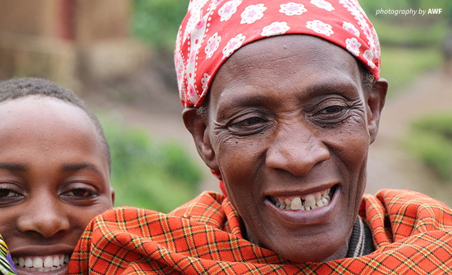 Close up photo of Rwandan woman and child smiling
