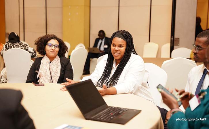 Simangele Msweli at a table at AMCEN