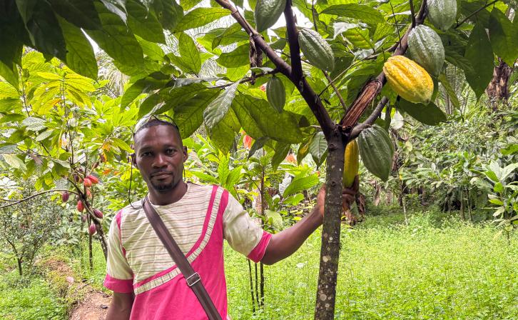 Zamo Yves standing in his 3.5 hectare cocoa farm in Nnemeyong in Southern Cameroon