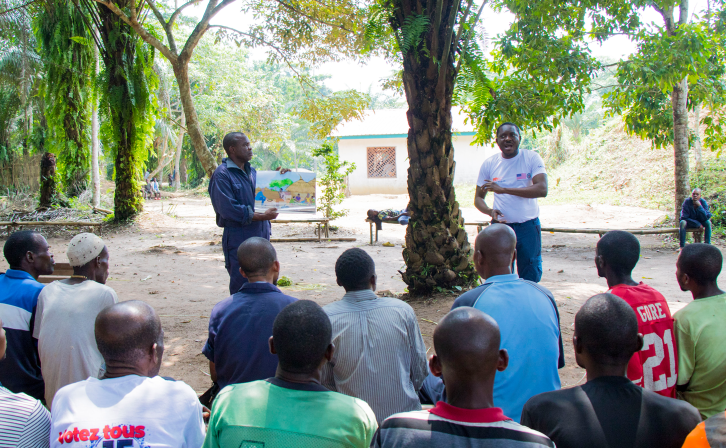Dodo Moke, AWF Senior Social Safeguards Officer, discusses rights-based conservation with community members in Ilima, DRC.