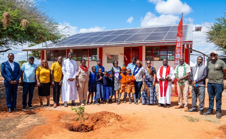 Nancy Githaiga, AWF Kenya Country Director, with partners and students in front of the solar-powered ICT lab following its official launch.