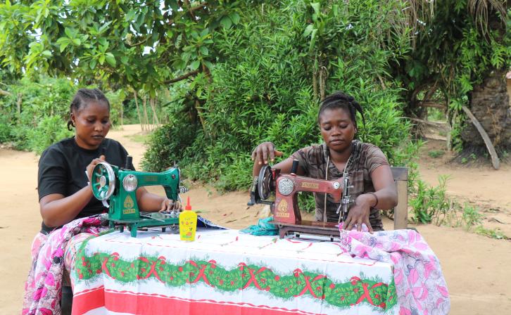 Two cousins practicing their sewing skills in their aunt’s compound, where she works as a trainer in Bongandanga.