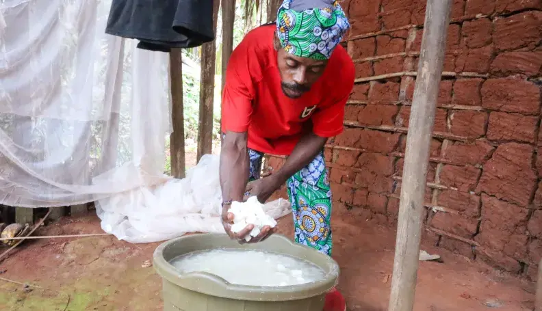 Ndamey Rene showing some of the cassava he harvested from his farm in January 2026
