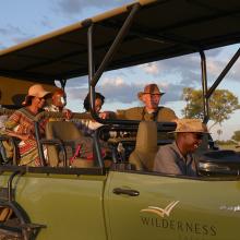 Photo of AWF staff and business leaders in safari vehicle