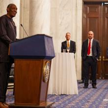 Photo of Kaddu Sebunya at a podium.