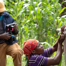 ACV fellow filming woman making water tank