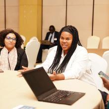 Simangele Msweli at a table at AMCEN