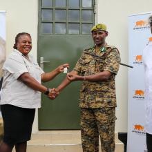 AWF and KWS shake hands in front of an evidence room.