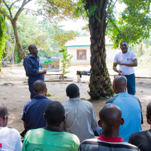 Dodo Moke, AWF Senior Social Safeguards Officer, discusses rights-based conservation with community members in Ilima, DRC.