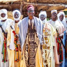Hayatou Adji, traditional ruler of Voko, stands in front of his palace with members of his council.