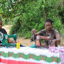 Two cousins practicing their sewing skills in their aunt’s compound, where she works as a trainer in Bongandanga.