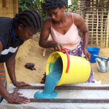Photo of three women making soap at AWF training center in the Democratic Republic of Congo