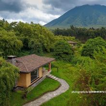 Photo of chalet at Sabyinyo Silverback Lodge in Rwanda with Mount Sabyinyo in the background