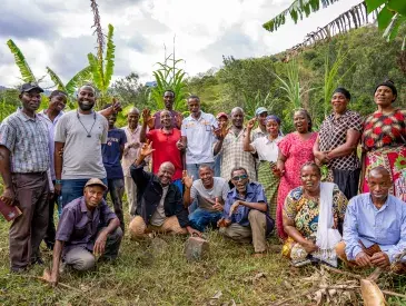 Chief Simon Mwakio (far left) with community members engaged in restoration efforts across Bura