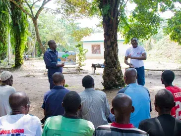Dodo Moke, AWF Senior Social Safeguards Officer, meets with members of the community.