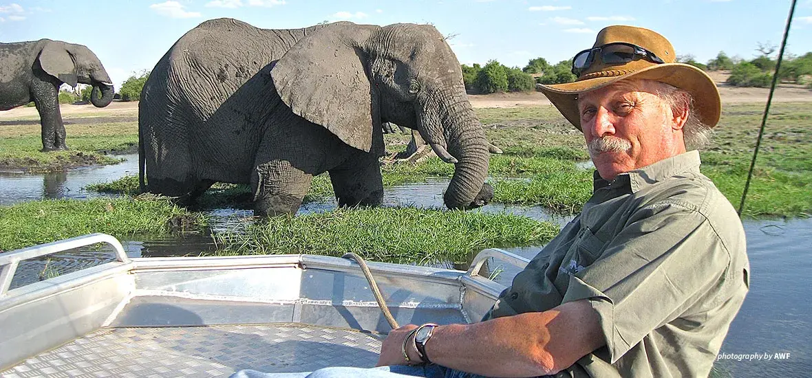 Photo of Craig Sholley with elephants in the background
